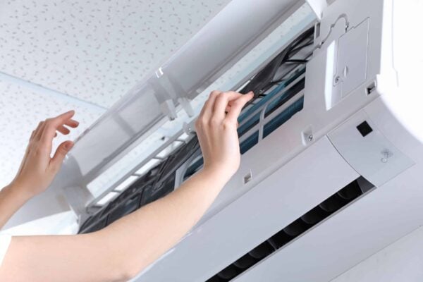 technician performing ac installation of ductless unit