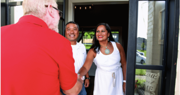 happy customers shaking hands with technician after hvac services