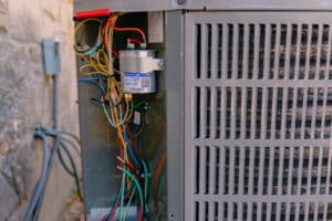 Open HVAC Unit with Exposed Wires